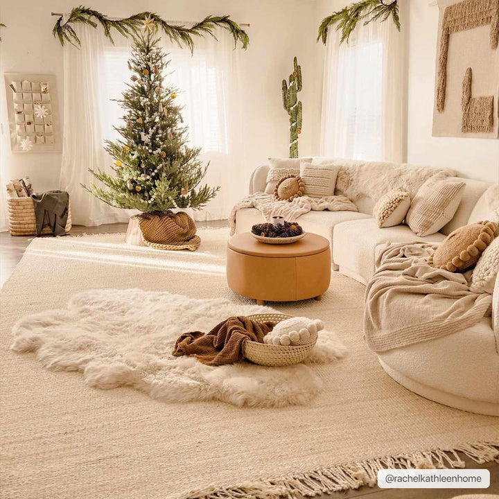 Cozy living room with a Christmas tree, beige sofa, and decorative items.

Iantha Jute Rug