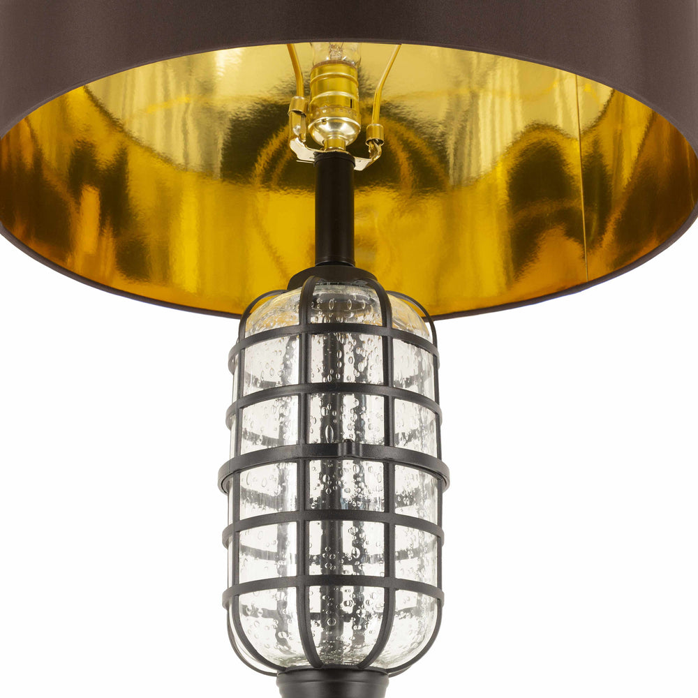 Close-up of a lamp with a gold shade and clear glass cage on a white background

Binuatan Floor Lamp