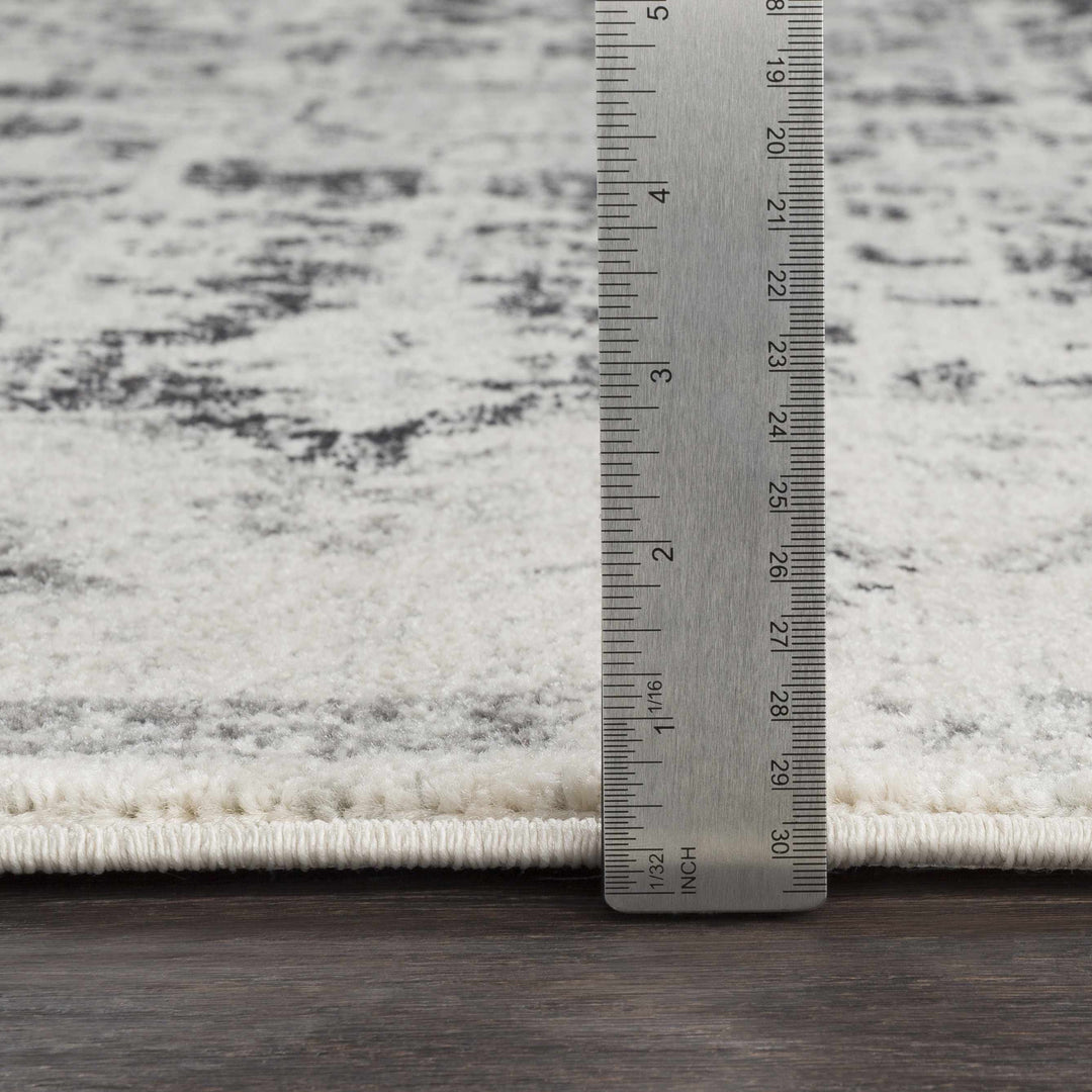 Rug with a ruler for scale on a wooden floor

Bodrum Gray Area Rug