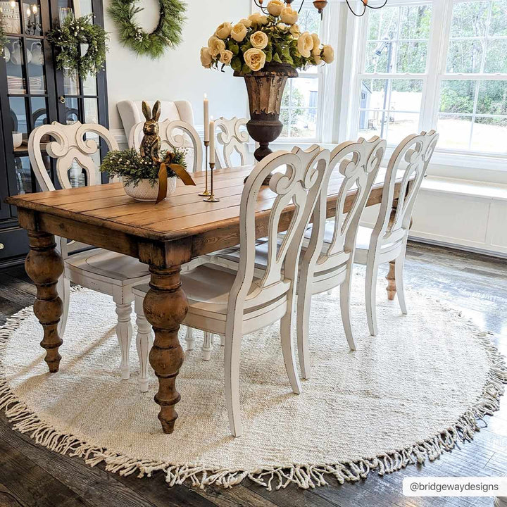 Dining room with wooden table and white chairs on a round rug.

Iantha Jute Rug