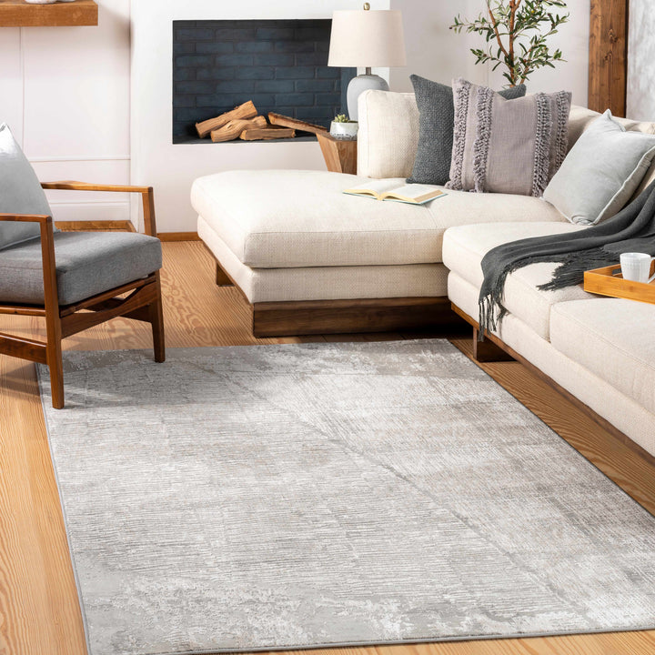 Modern living room with a gray rug, white sofa, and wooden chair.

Leeco Textured Luxe Rug