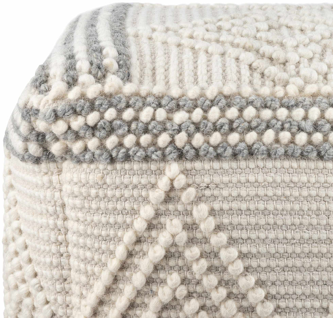 Textured ottoman with a patterned design in gray and white.

Murgon Cream W Wool Pouf