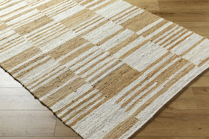 Patterned rug with beige and white stripes on a wooden floor