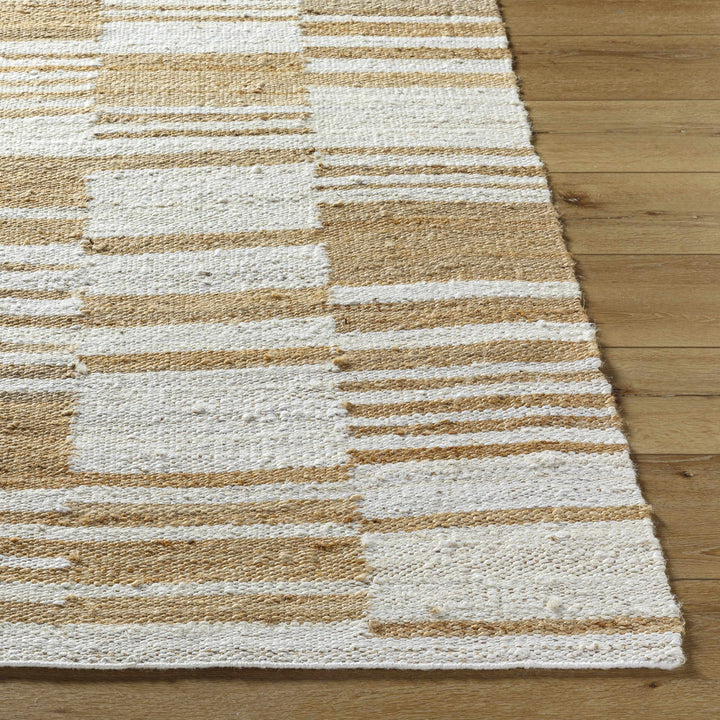 Textured area rug with brown and beige stripes on a wooden floor