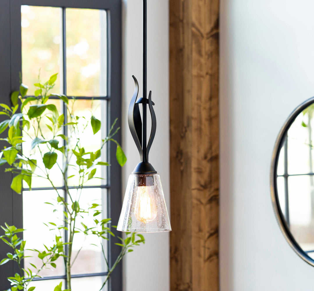 Modern pendant light fixture with a clear glass shade in a room with a window and plant.

Collinswood Ceiling Light
