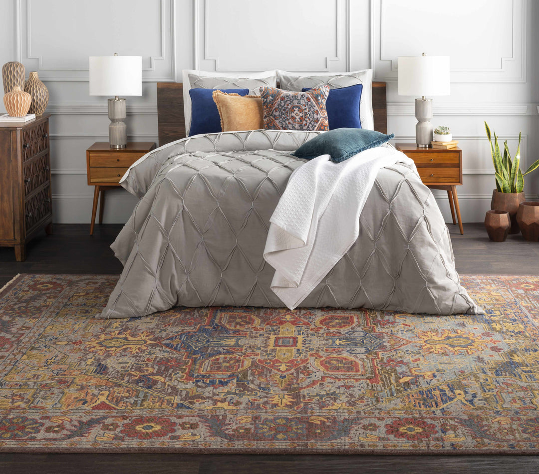Bedroom with a bed featuring a gray comforter and colorful pillows, on a patterned rug.

Mulauin Triditional Glass Decorative Accent