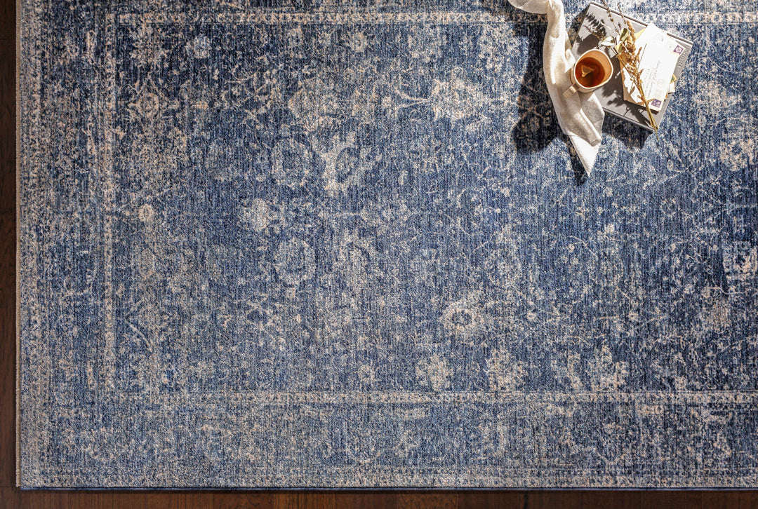 Blue patterned rug with a candle and decorative items on a wooden floor

Eastham Luxe Area Rug