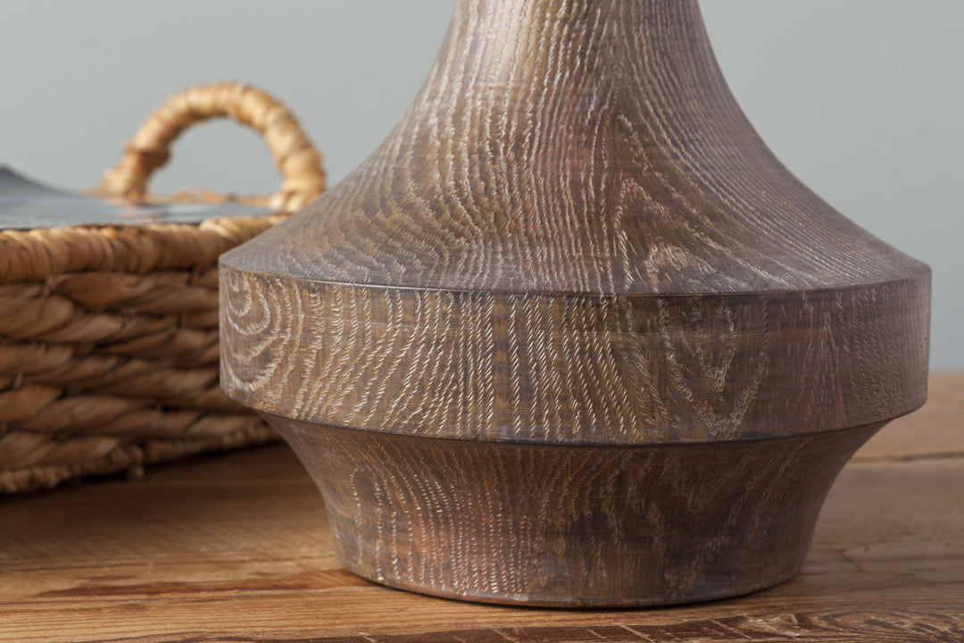Wooden lampshade on a wooden surface with a wicker basket in the background

Kabankalan Seagrass Resin Table Lamp