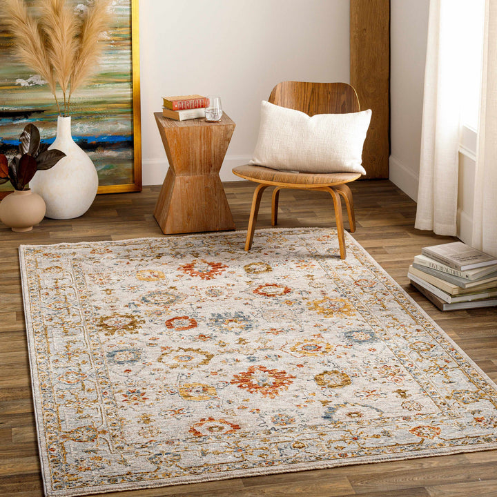 Decorative rug with floral pattern in a living room setting with a chair and side table.

Mogul Luxe Oushak Rug