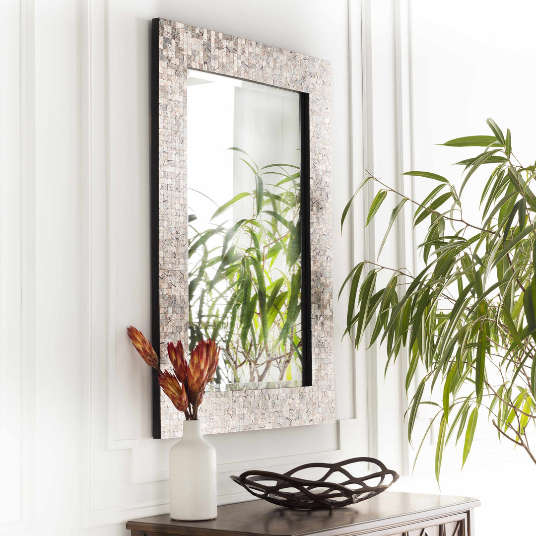 Decorative mirror with a decorative vase and bowl on a console table in a room with plants.

Nicolet Marble Mirror