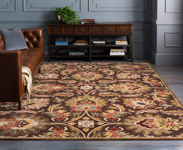 Decorative rug with floral pattern in a room with a brown sofa and wooden cabinet.