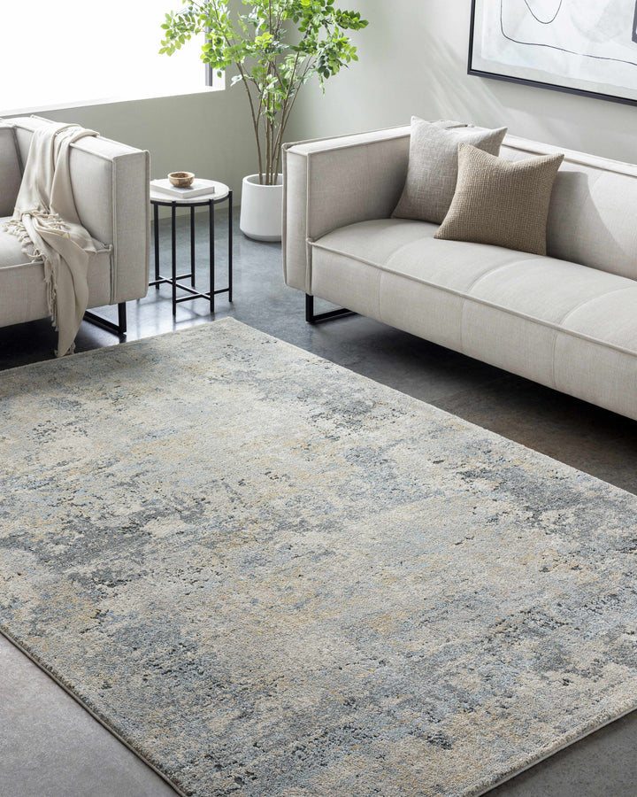 Living room with a gray and blue patterned rug, beige sofa, and side table.

Adamma Thick Luxe Rug