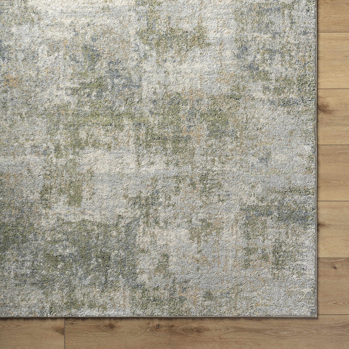 Textured area rug with a mix of gray, beige, and green colors on a wooden floor.

Zazie Thick Luxe Rug